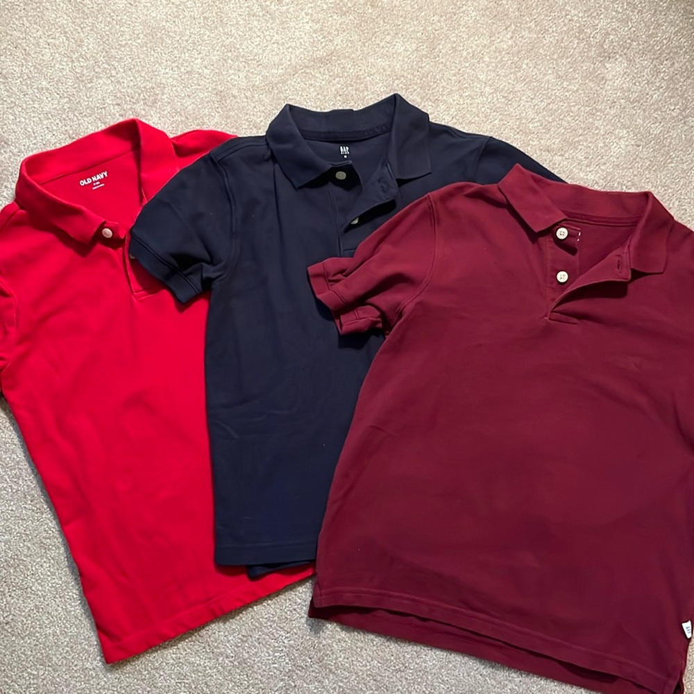 Three short sleeve polo style shirts. Red, blue, burgundy
